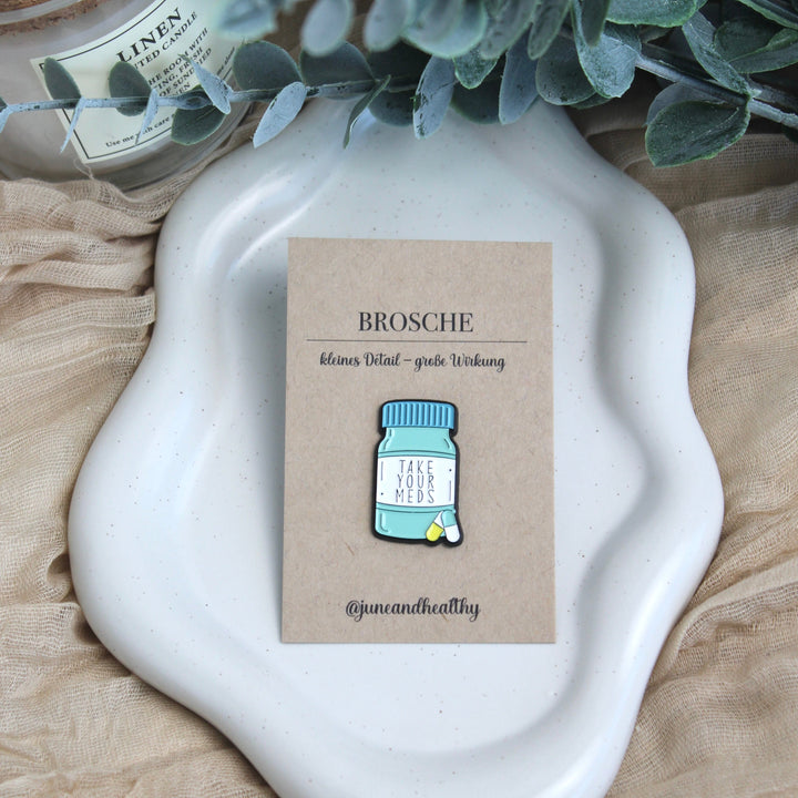 Brosche "take your meds"